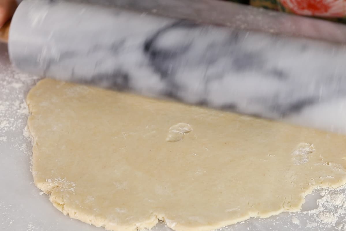 rolling our pie crust on a marble board