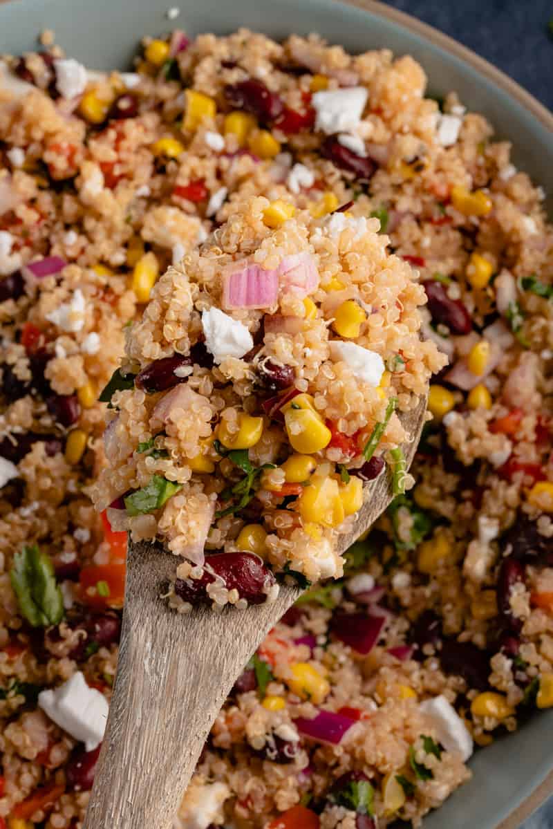 close up of wooden spoon full of vegan quinoa salad
