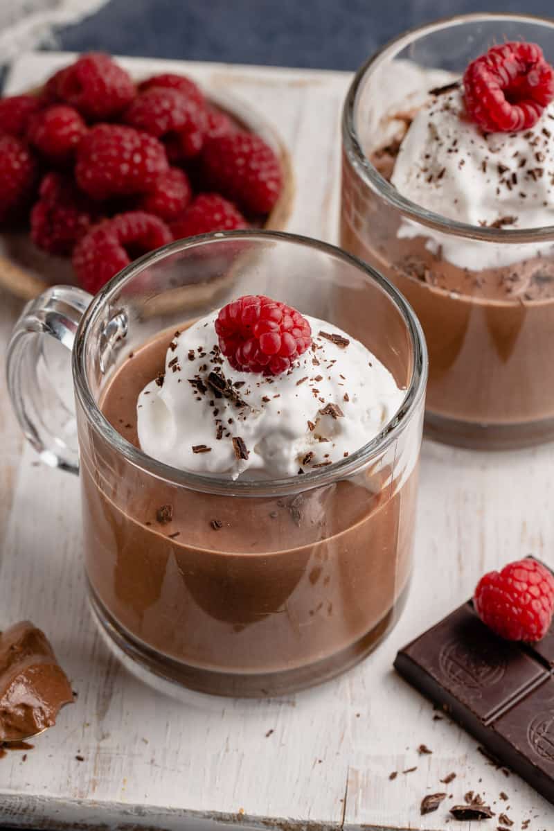 chocolate mousse in cup with whipped cream and fruit