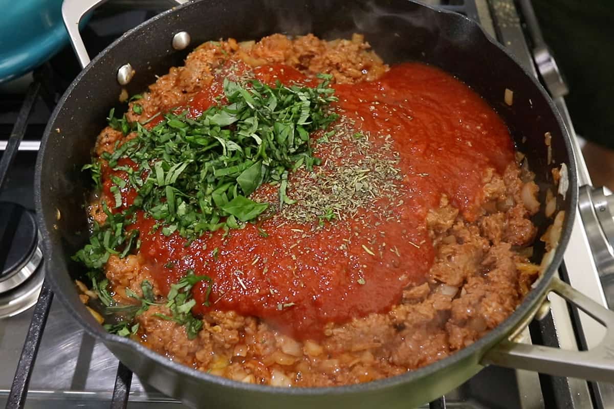 making vegan meat sauce in black pan for baked ziti