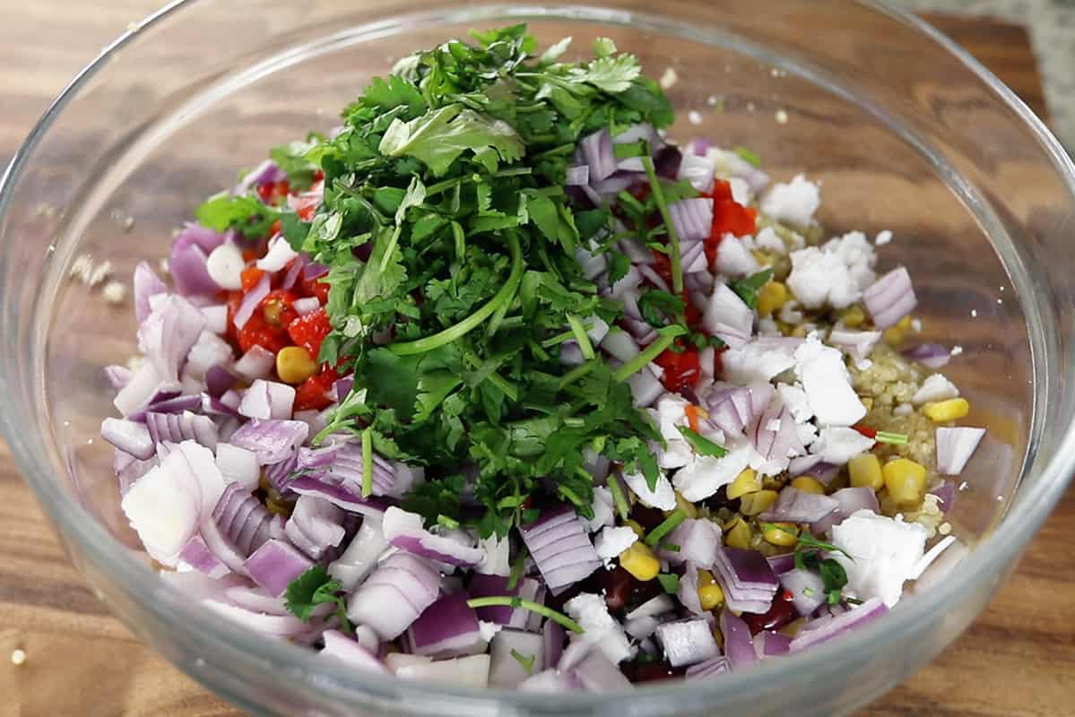 ingredients for vegan quinoa salad in glass bowl