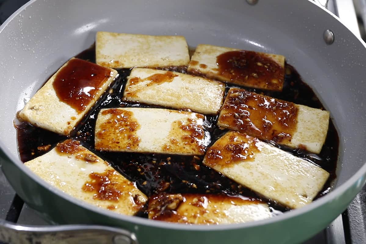 Tofu pieces with sauce in pan