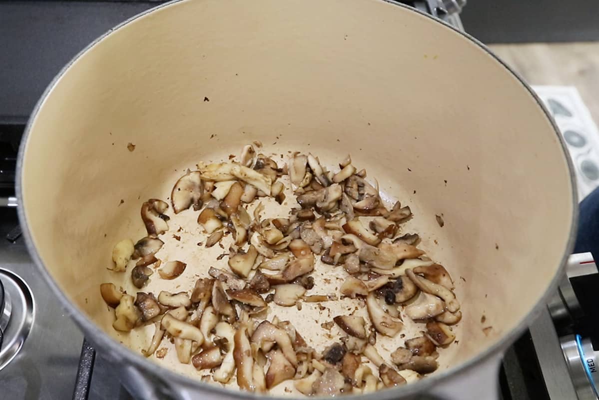 cooking oyster mushrooms in pot with vegan butter