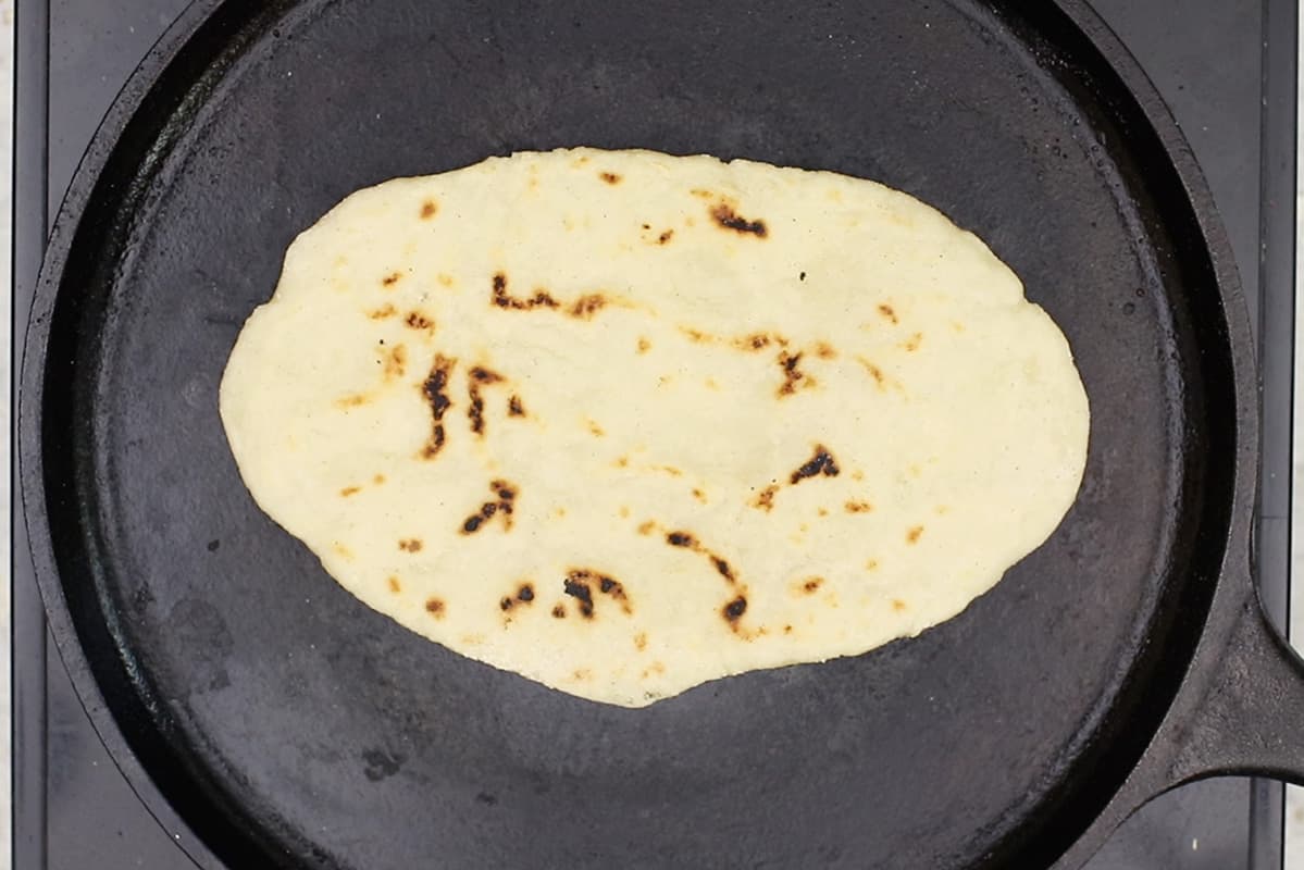 cooking gluten-free flatbread on cast iron griddle