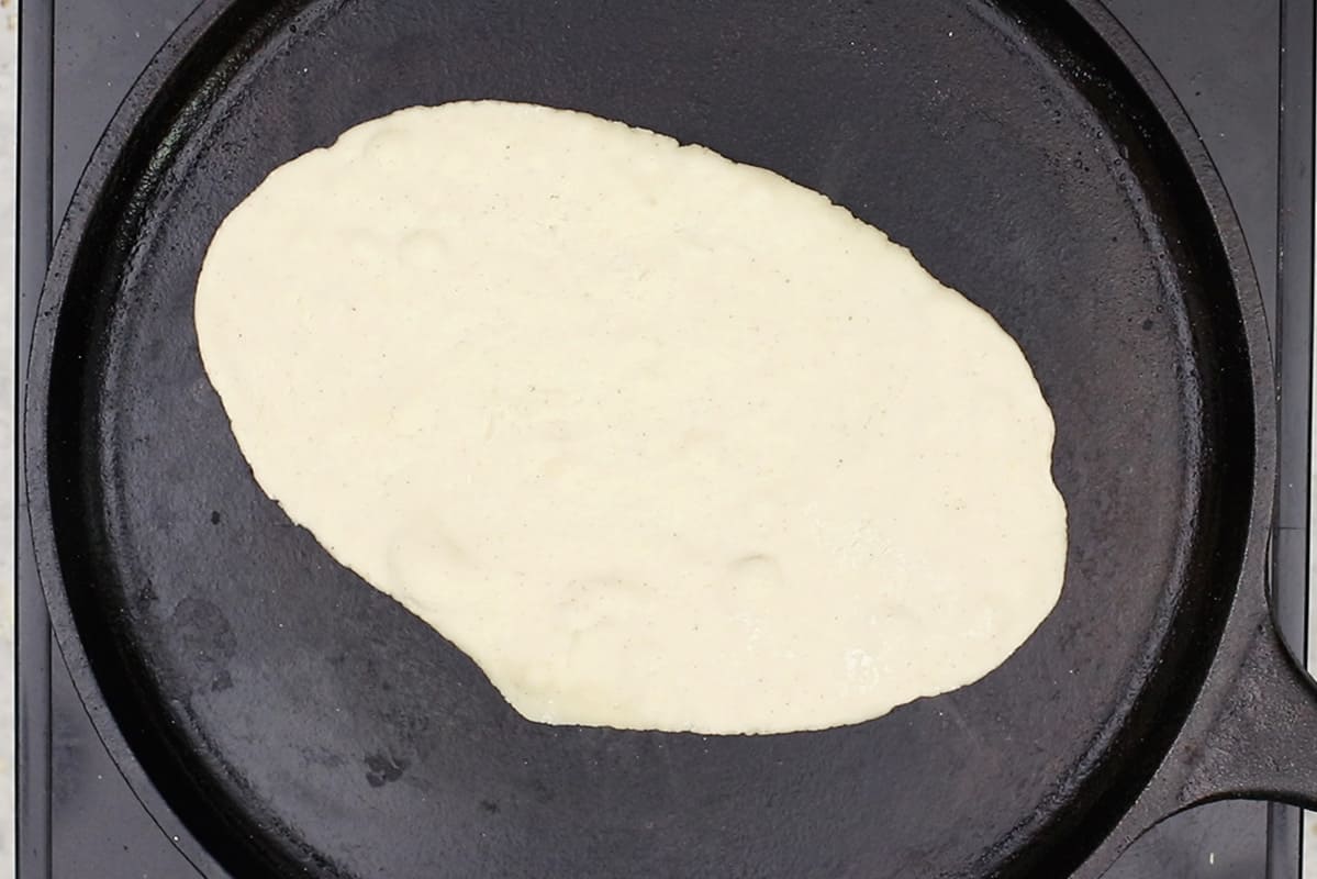 cooking gluten-free flatbread on cast iron griddle