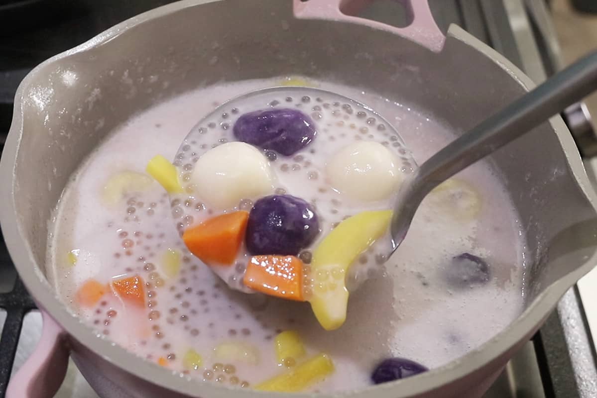 close up photo of ginataang bilo biilo being scooped out of pot with a metal ladle