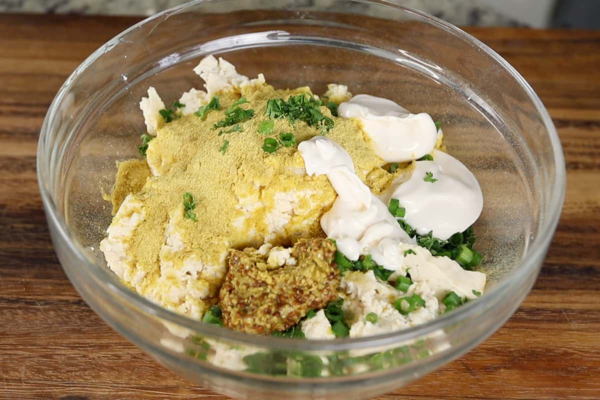 step by step preparation of vegan tofu egg salad in glass bowl