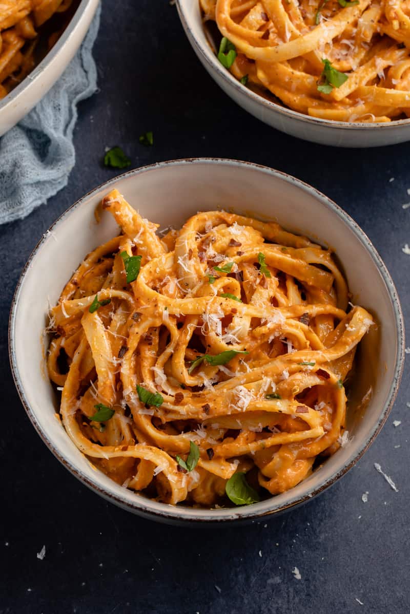 roasted red pepper sauce fettuccine in gray bowl