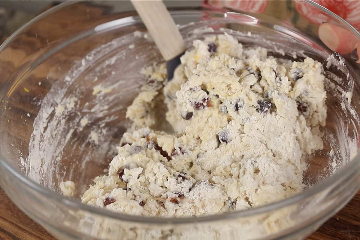 making dried cherry scones dough in a glass bowl
