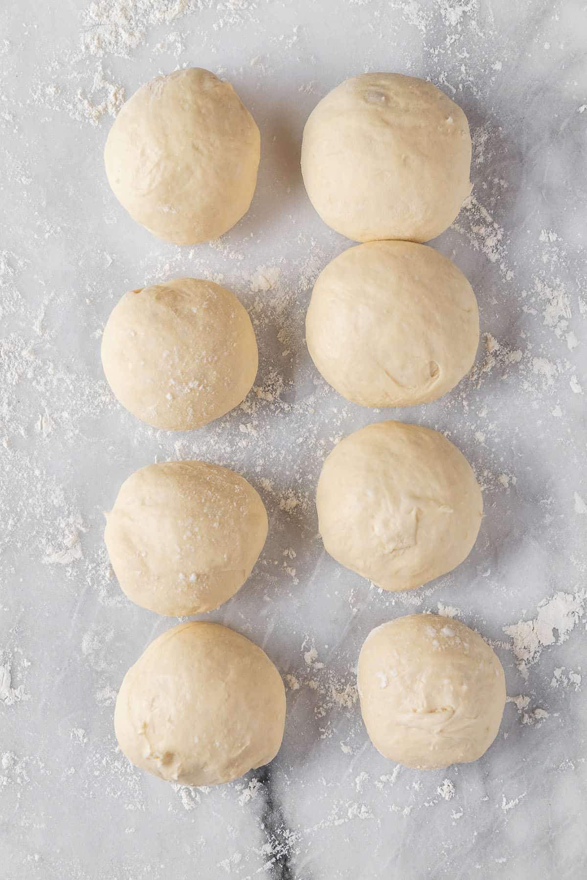 pita bread dough rising on marble board