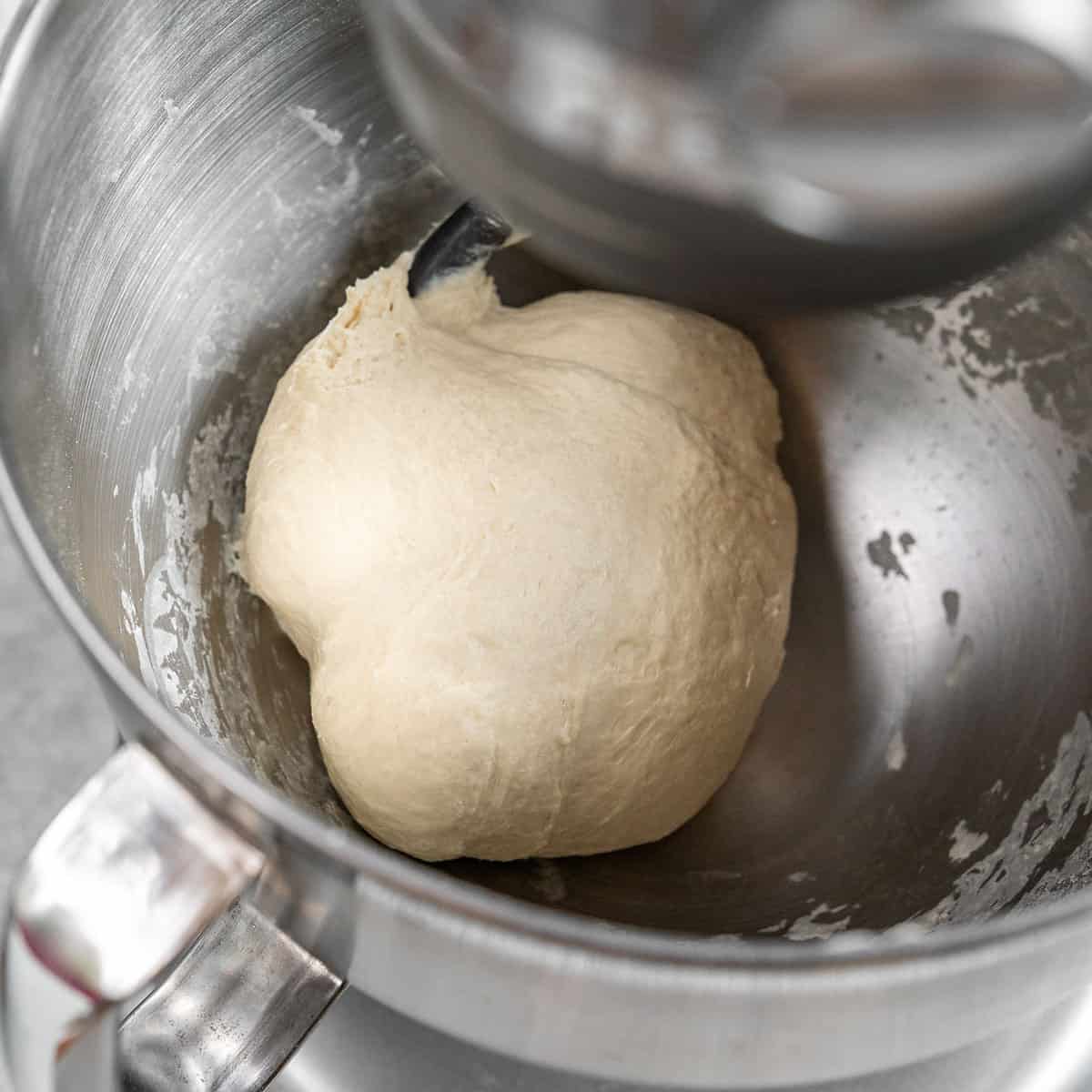 making pita bread dough in a stainless steel standing mixer