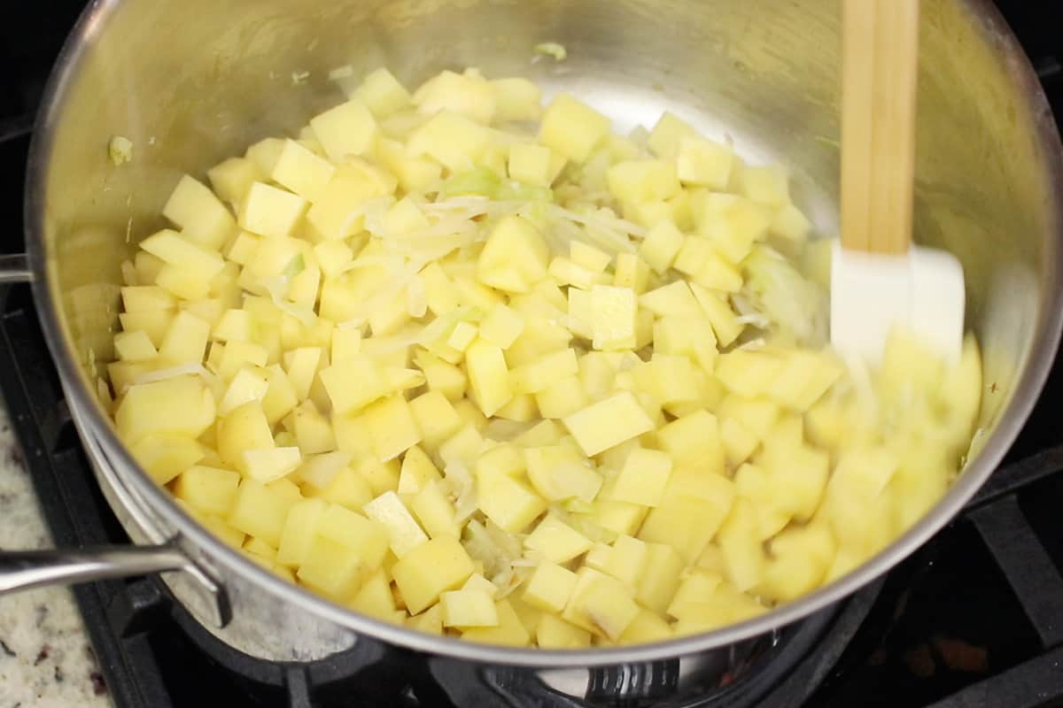 cooking potato leek soup in a stainless steel pot