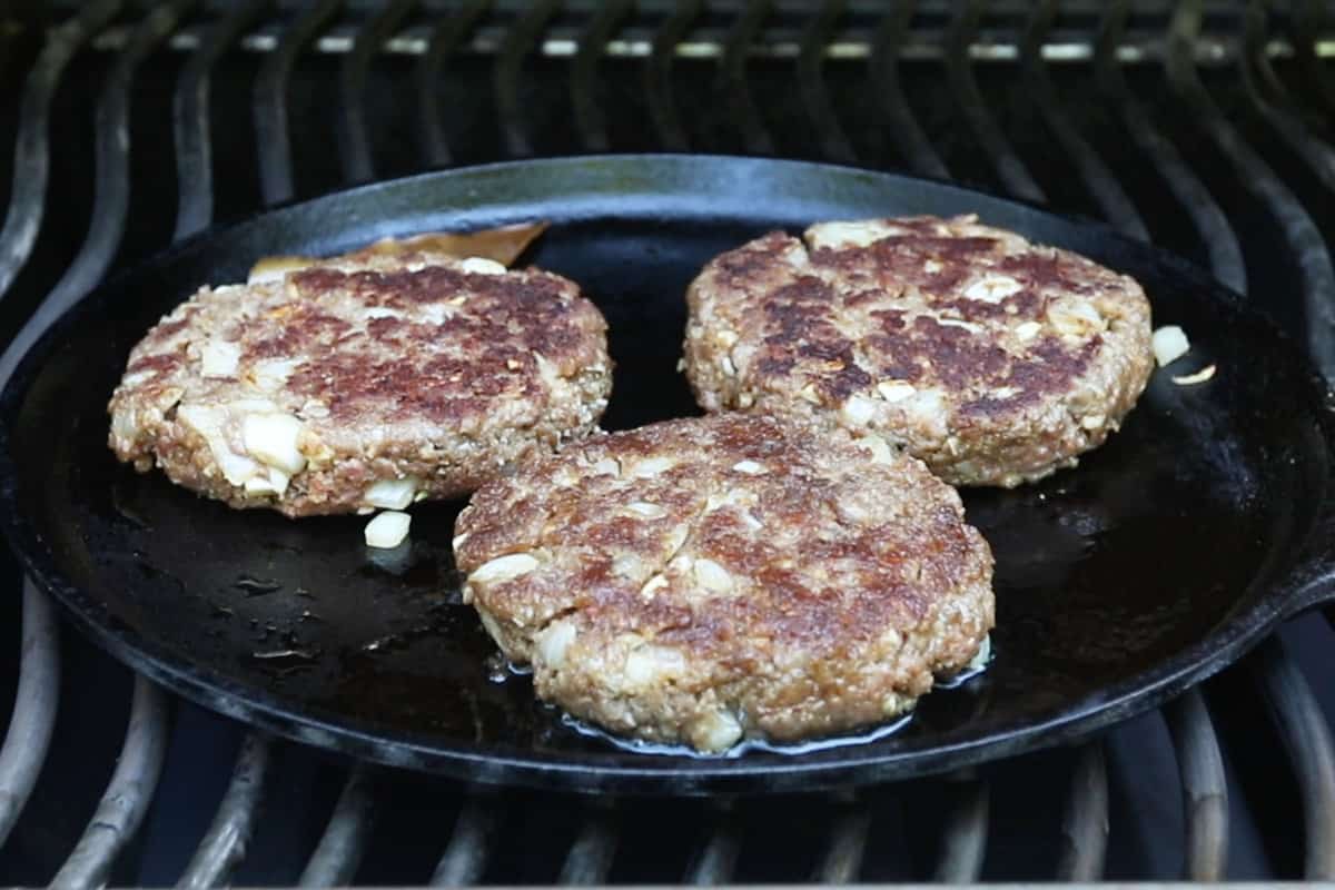 grilling burgers on cast iron skillet