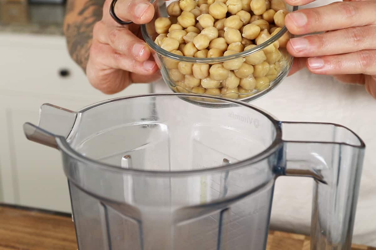 adding chickpeas to vitamix for hummus