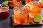 Strawberry Mojito Mocktails on a wooden board and blue table