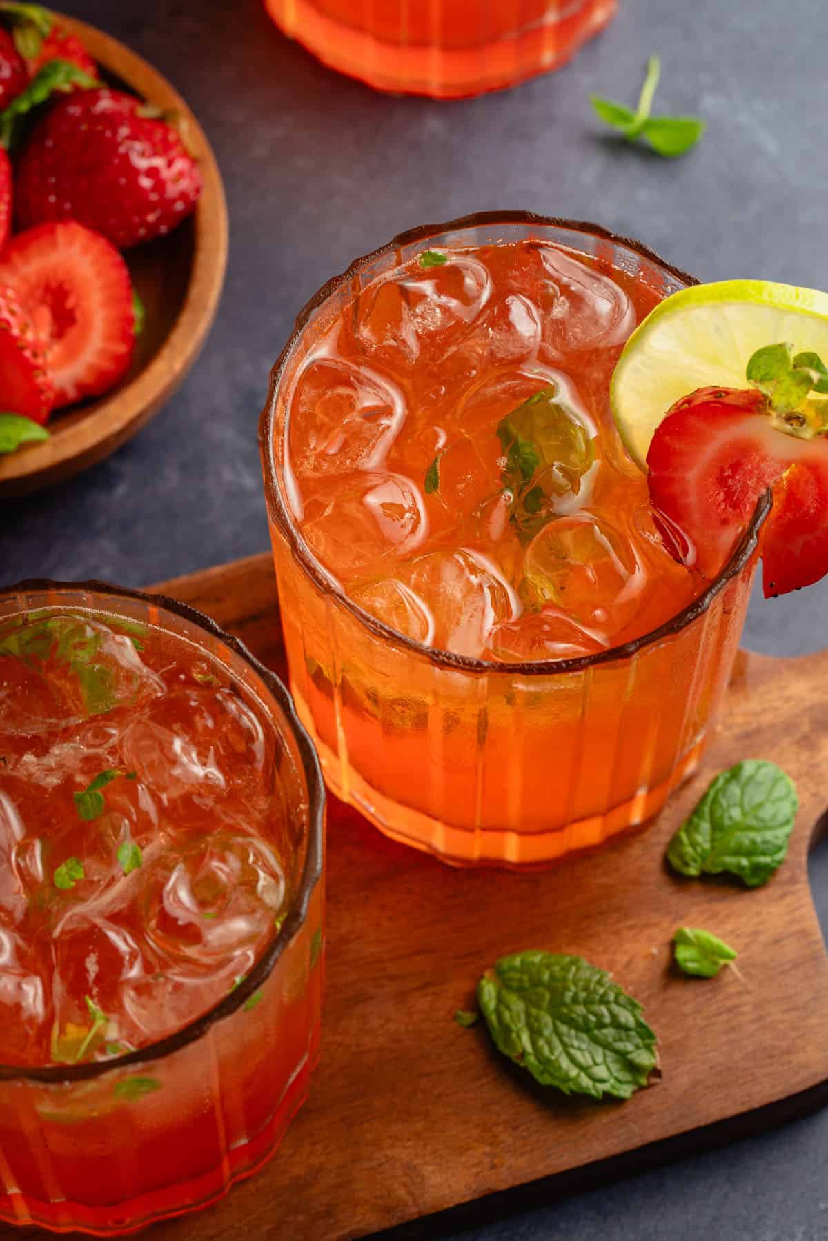 Strawberry Mojito Mocktails on a wooden board and blue table