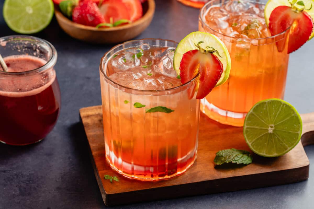 Strawberry Mojito Mocktails on a wooden board and blue table