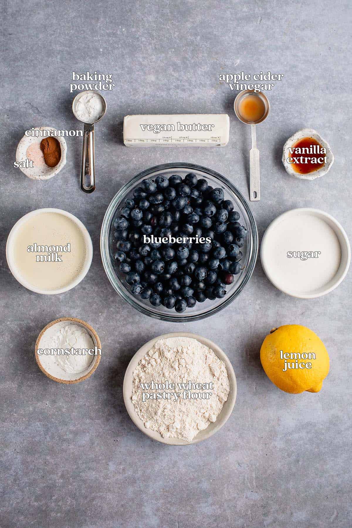 labeled ingredients for blueberry cobbler on gray board