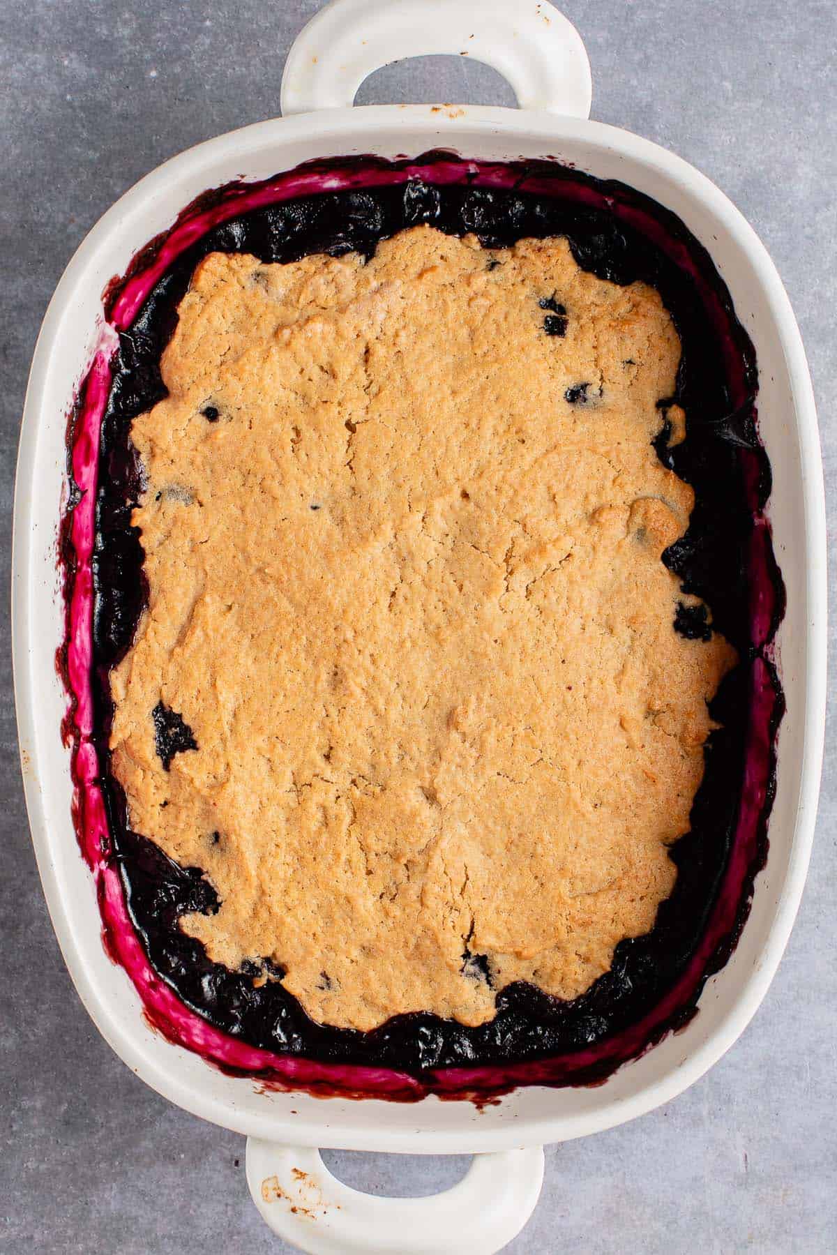 blueberry cobbler in white baking dish after baking