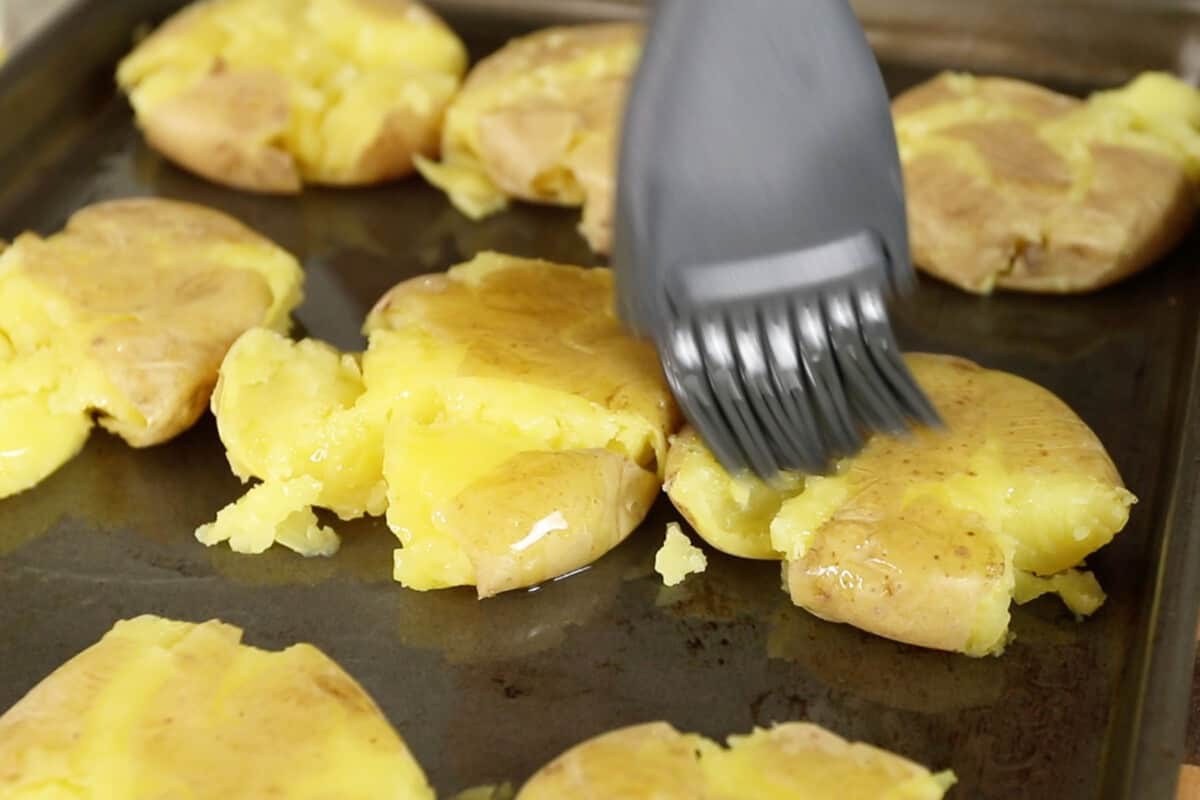 brushing smashed potatoes with oil