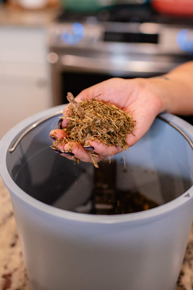 hand holding compost created by Lomi Bloom