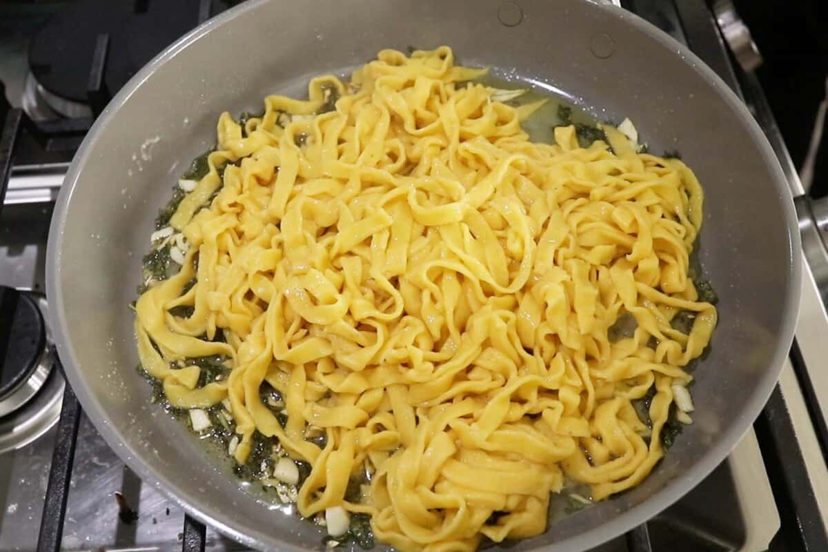 fresh pumpkin pasta in pan with sage butter sauce