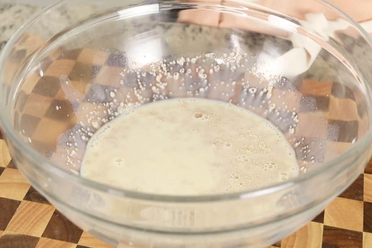 active dry yeast in glass bowl with almond milk and sugar