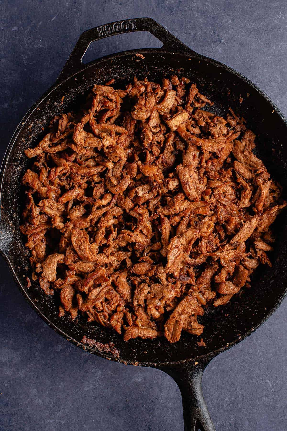 charred soy curls in cast iron skillet for vegan Philly cheesesteak recipe