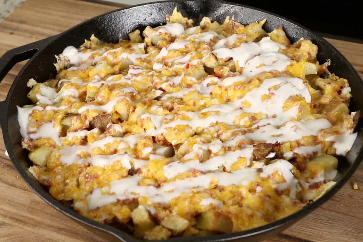 step by step loaded baked potato skillet with sour cream drizzled