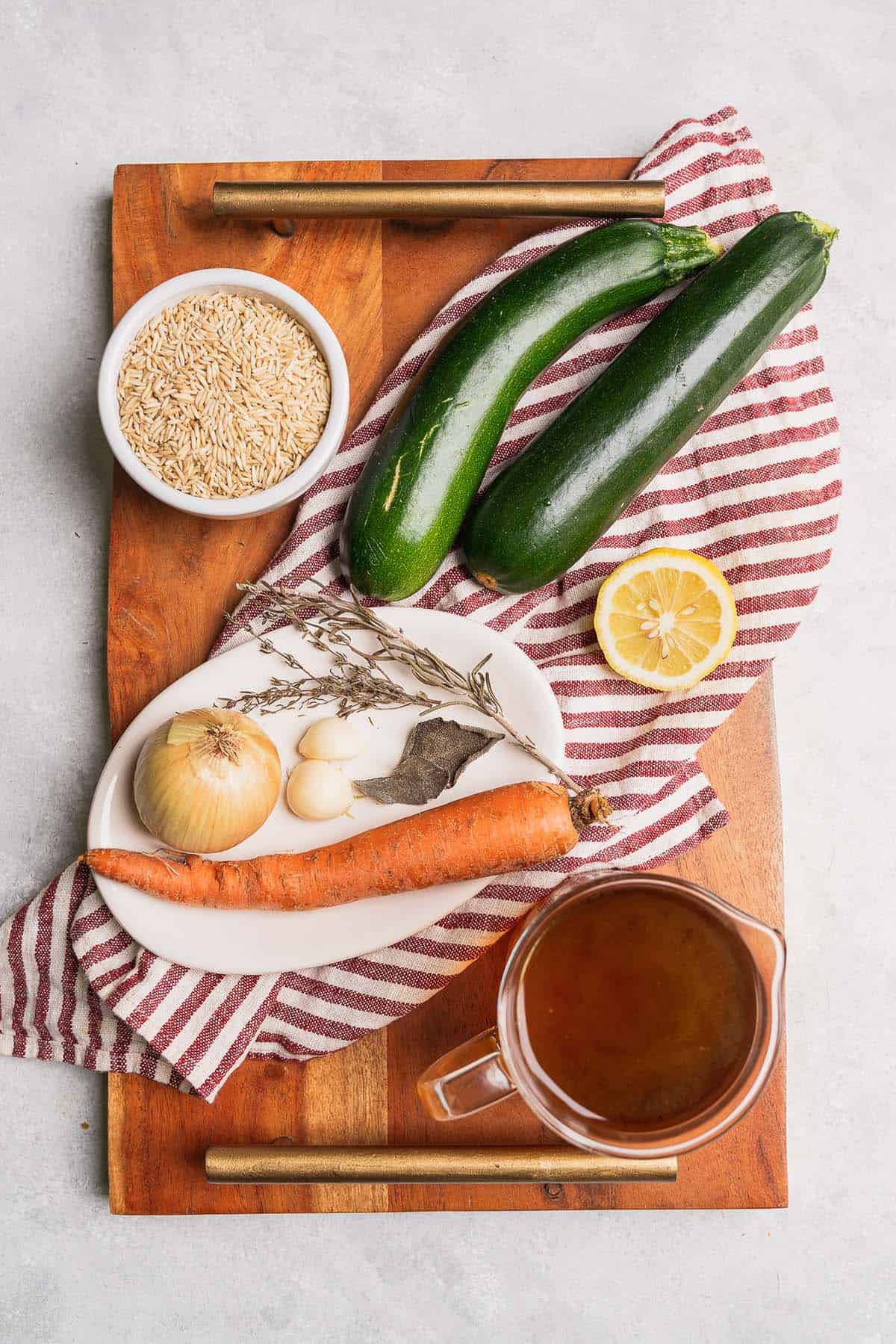 rice, zucchini, onion, garlic, thyme, bay leaf, carrot, broth, lemon