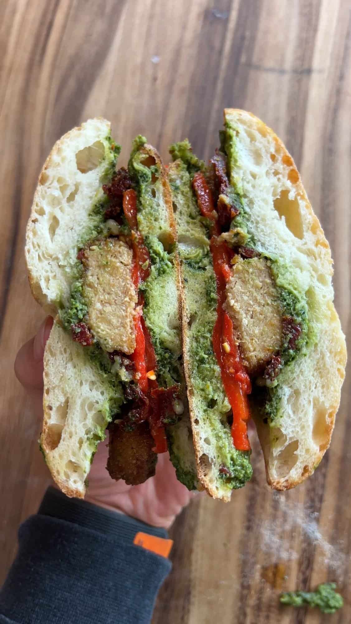 Vegan Chicken Pesto Sandwiches sliced down the middle with cross section showing