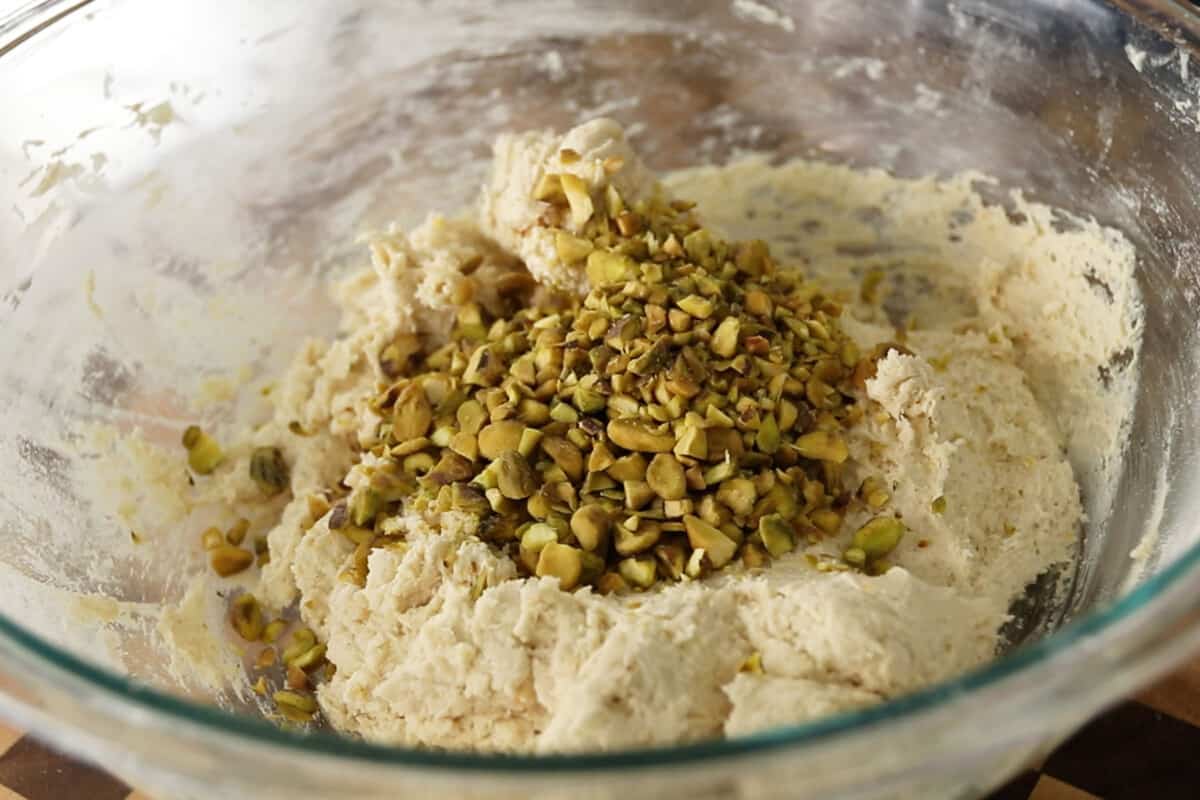 step by step - pistachios added to dough in bowl