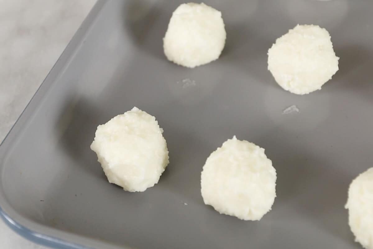 cream cheese balls on baking sheet