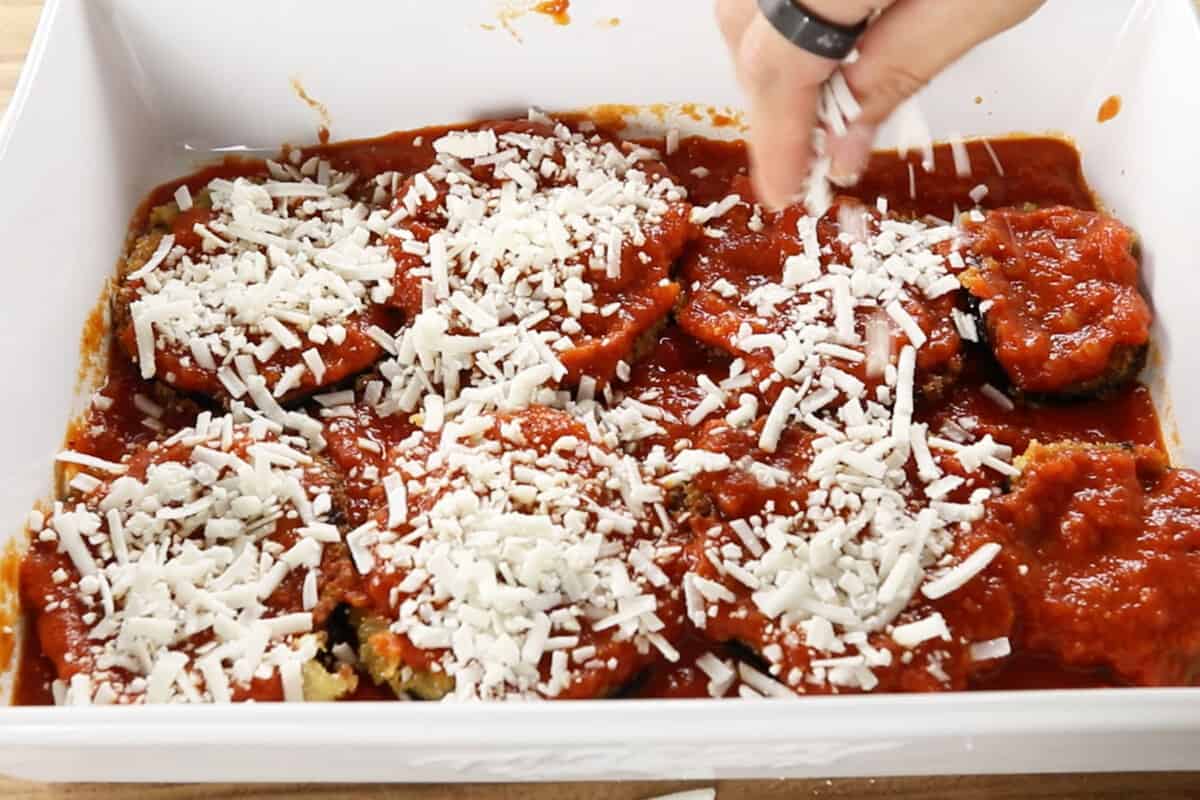 step by step - sprinkling cheese over eggplant in baking dish