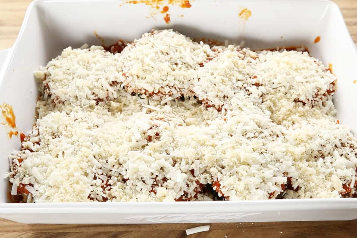 step by step - adding more cheese over the eggplant in baking dish