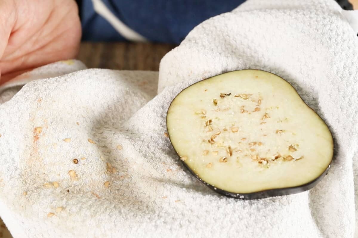 step by step - eggplant being pat dry after sweating