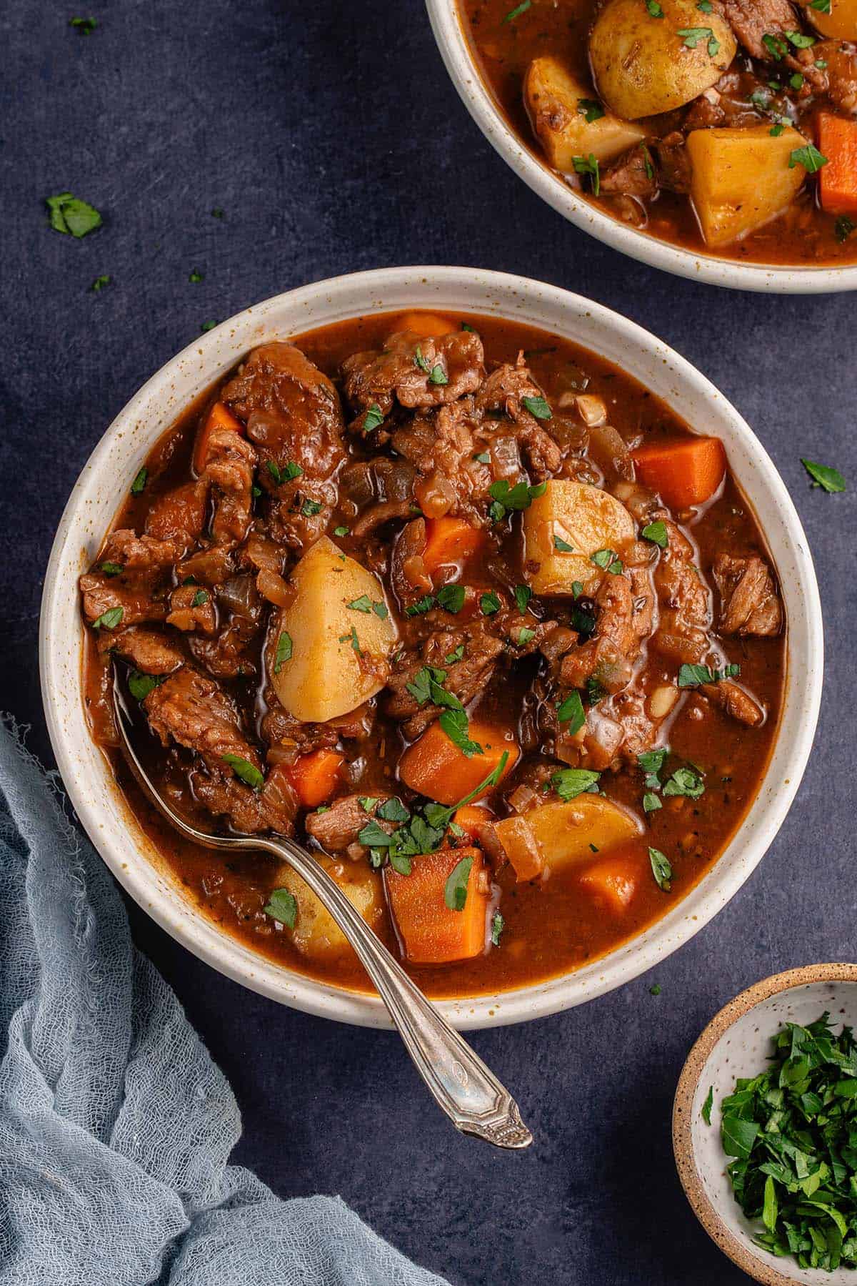 bowl of beef stew on blue background