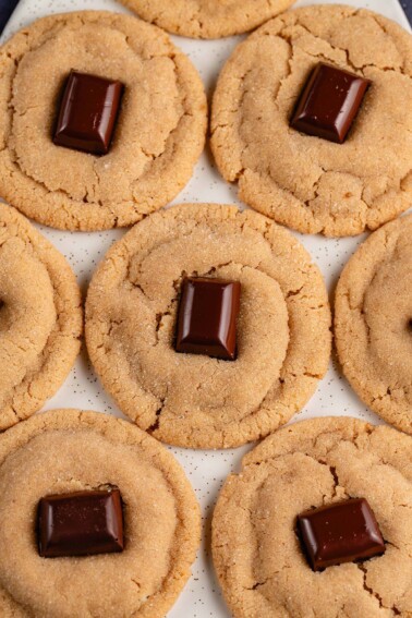 overhead image peanut butter blossom cookies on white tray