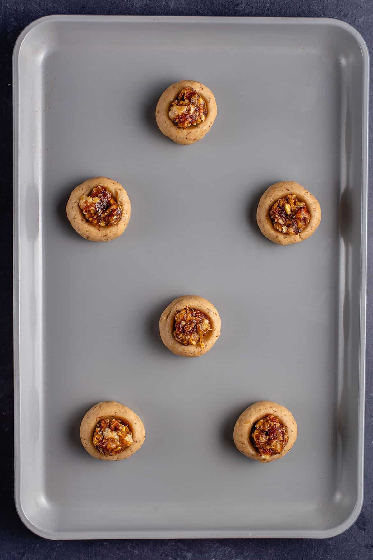 uncooked baklava cookies on a baking sheet