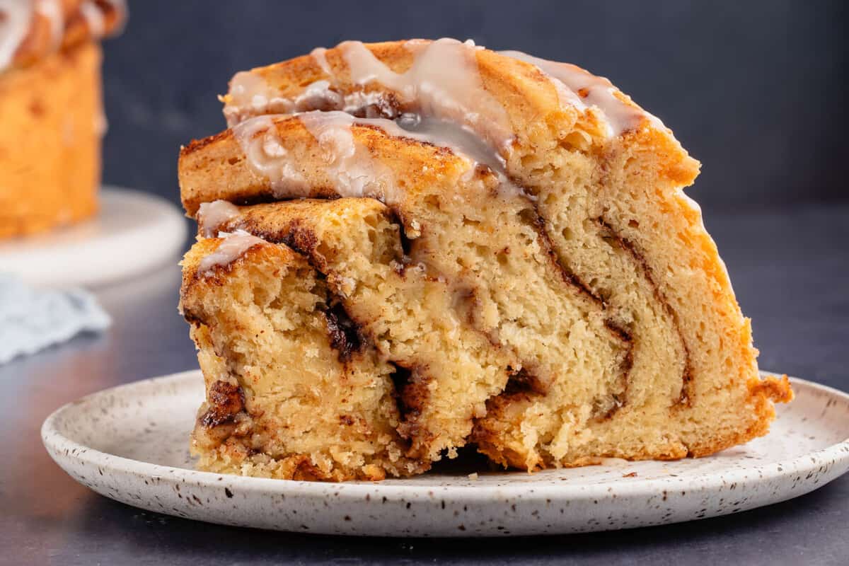 up close image of cinnamon roll cake slice on a plate