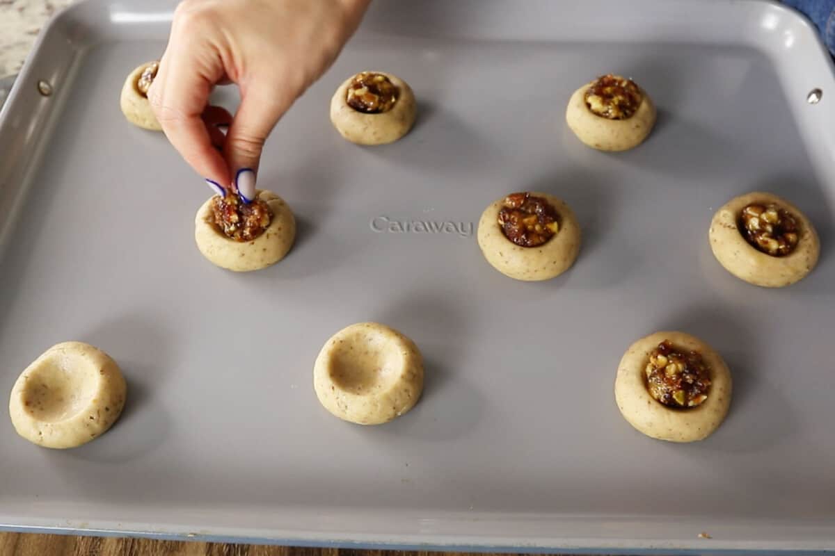 Unbaked Baklava Cookies being filled on baking sheet