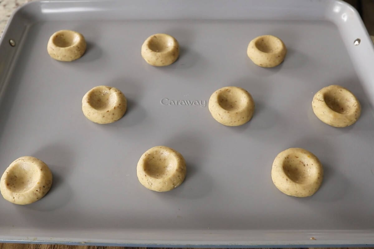 unbaked cookies on a baking sheet before adding the filling