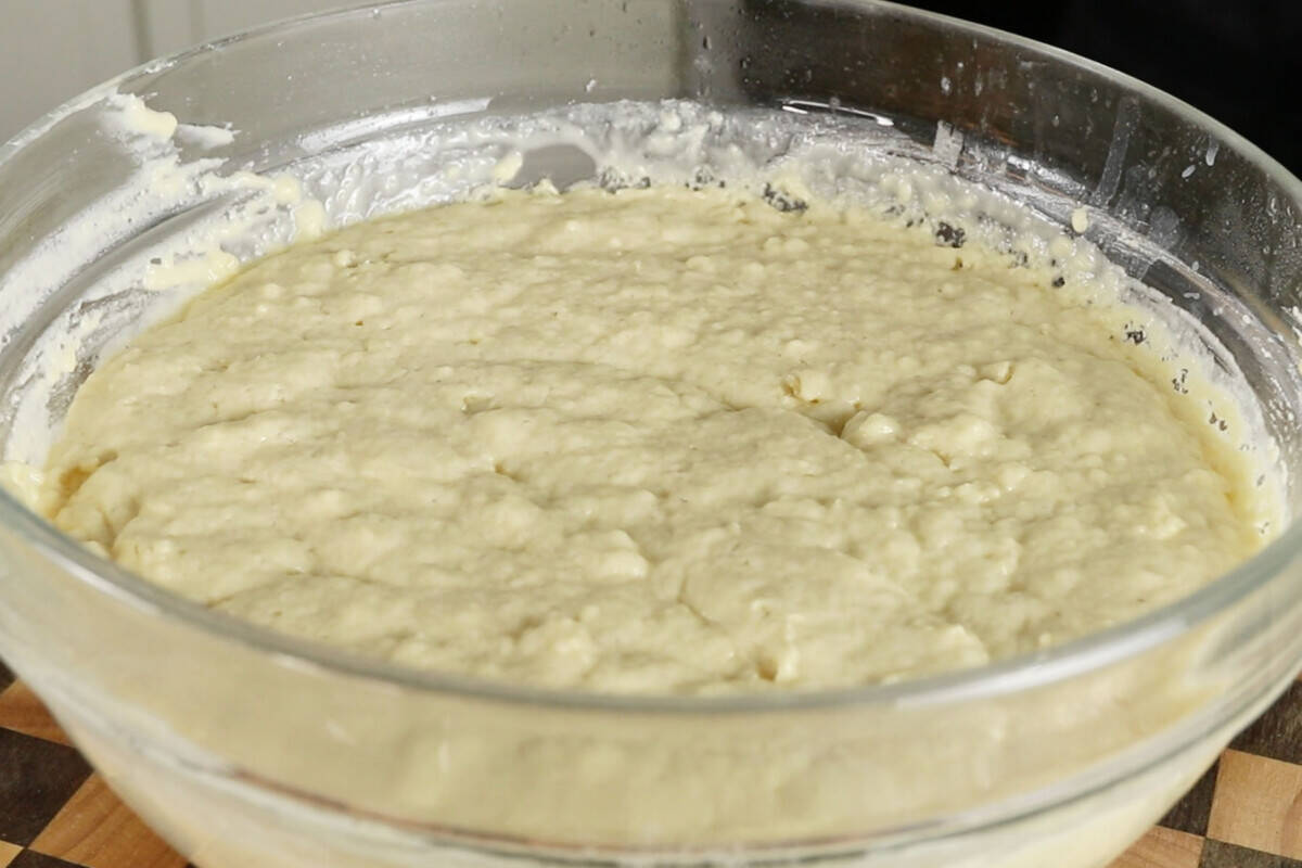 risen dough in a glass bowl