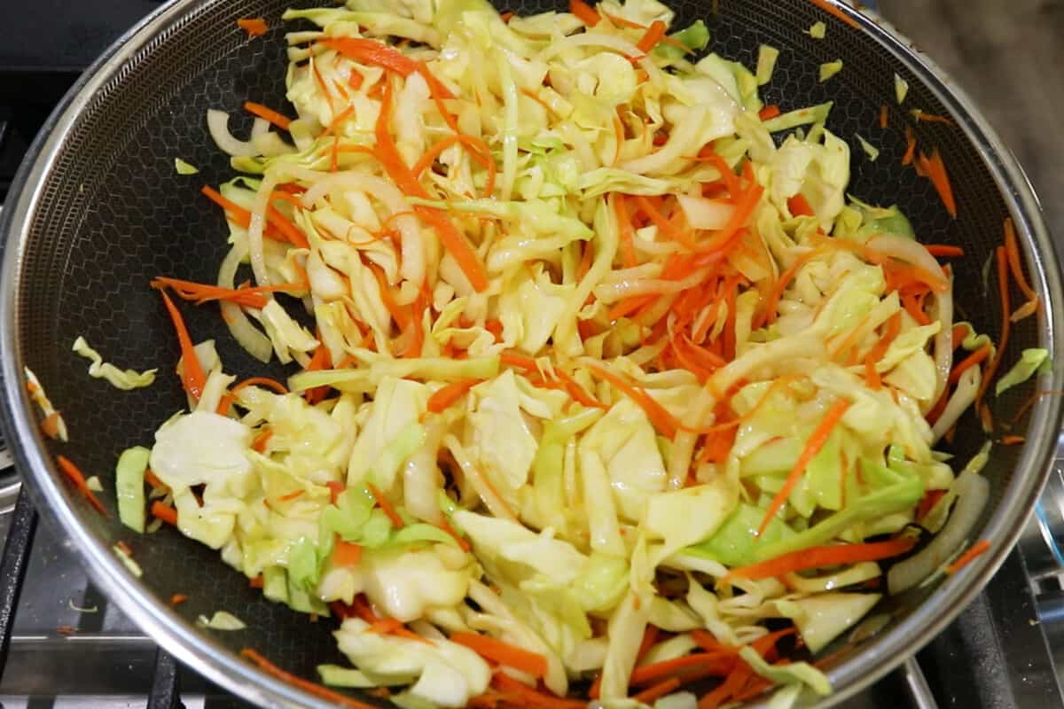 step by step of vegetables cooking in a wok