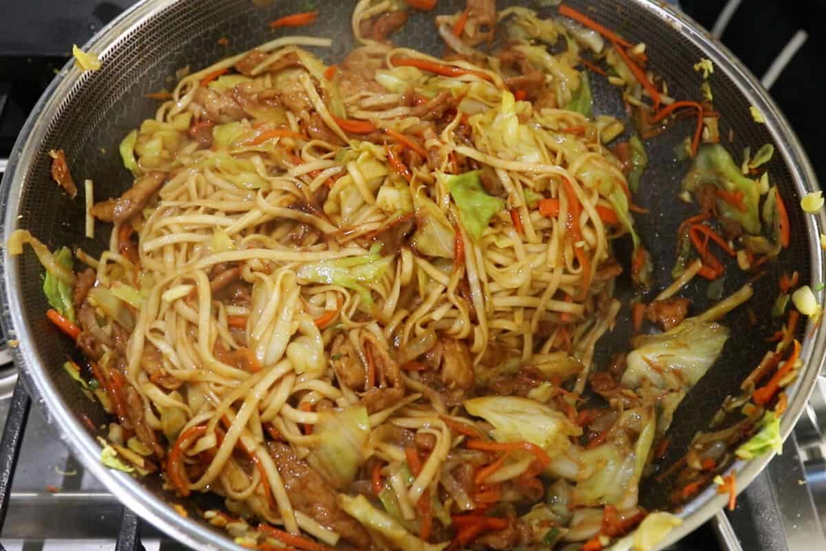 step by step lo mein cooked in a wok
