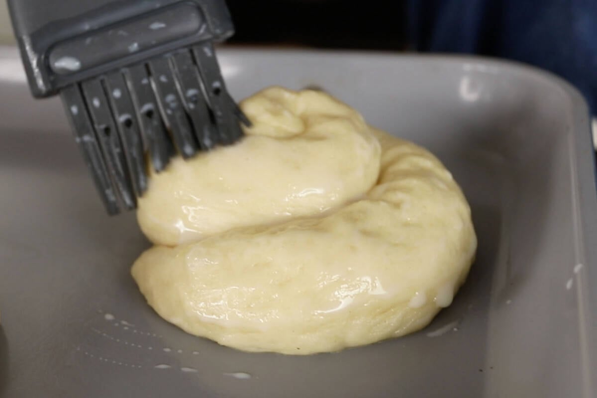 brushing ensaymada dough with milk