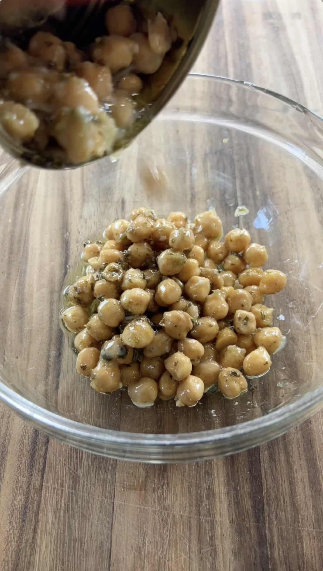 chickpeas being poured into a bowl