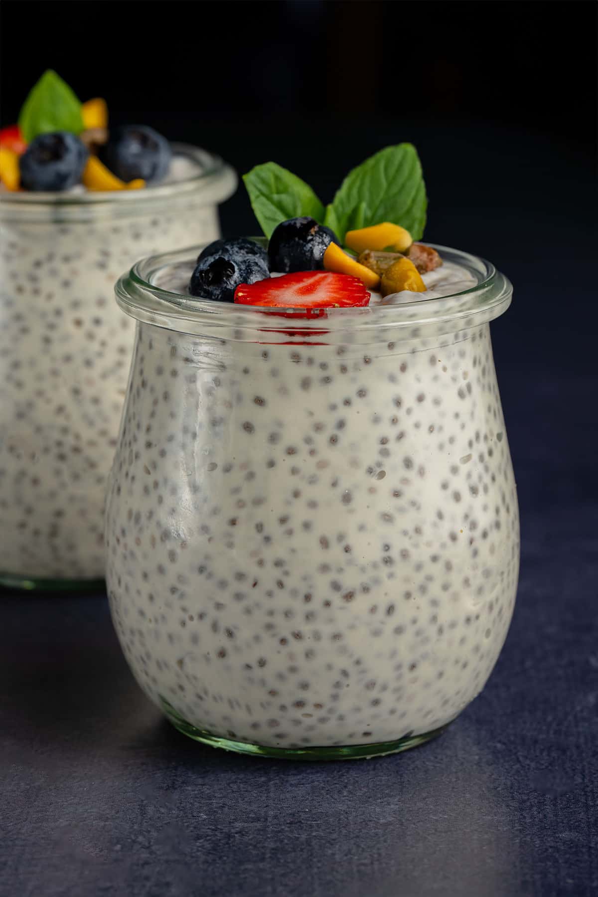 Vegan Chia Pudding with Yogurt in glass weck jar with fruit and nuts
