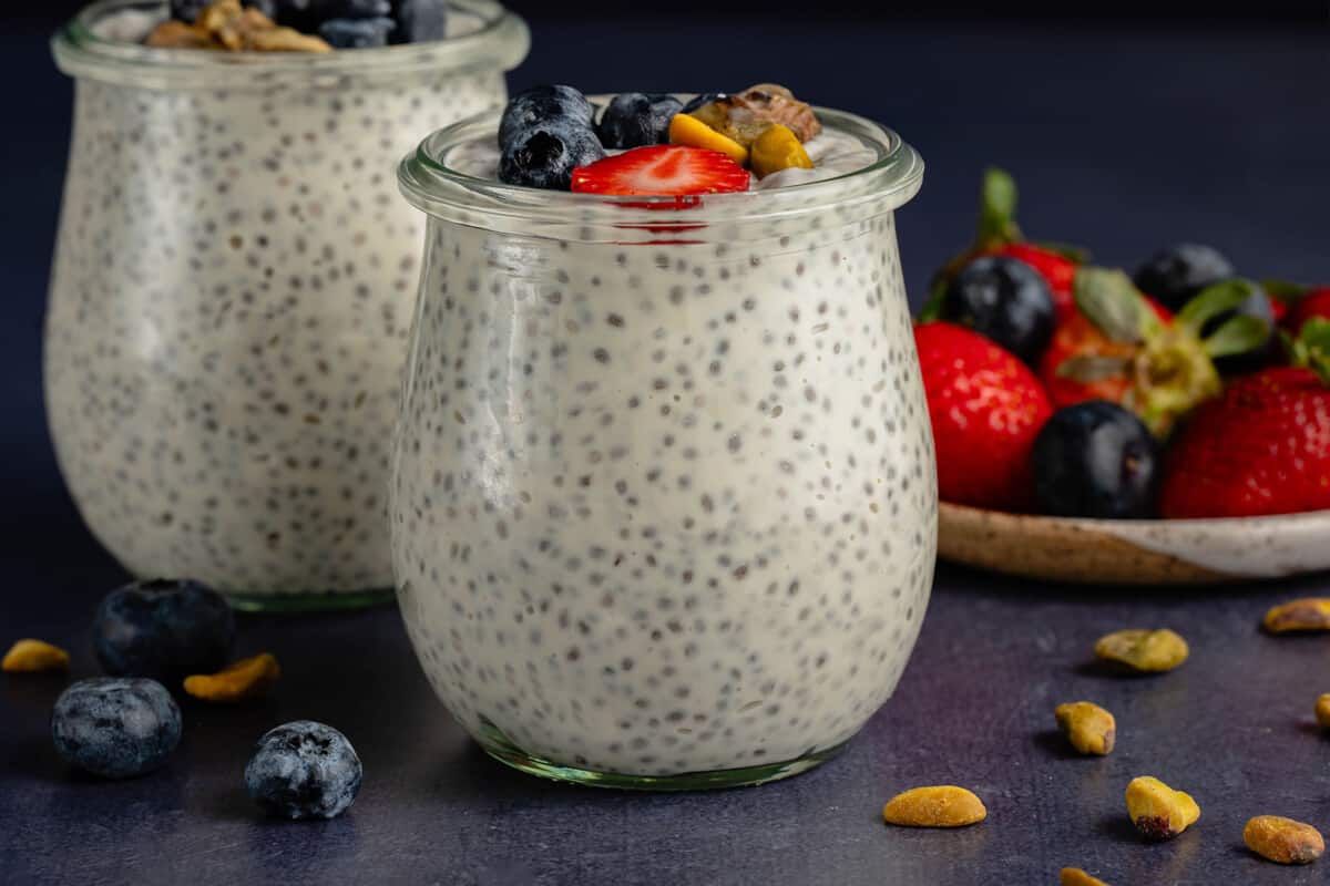 horizontal photo of Vegan Chia Pudding with Yogurt in glass weck jar with fruit and nuts