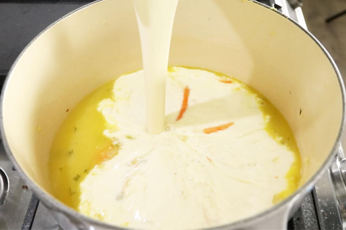 adding cream to soup in dutch oven